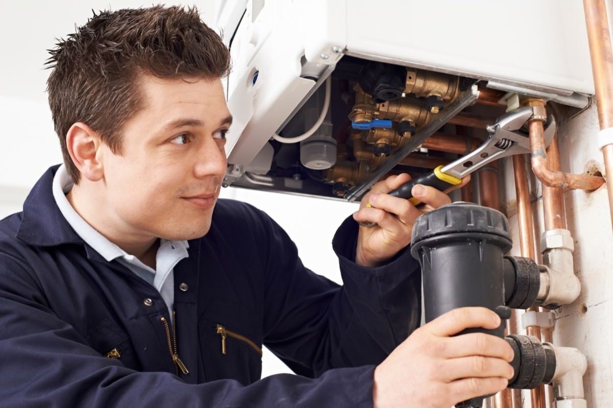 photo showing engineer fitting a magnetic filter